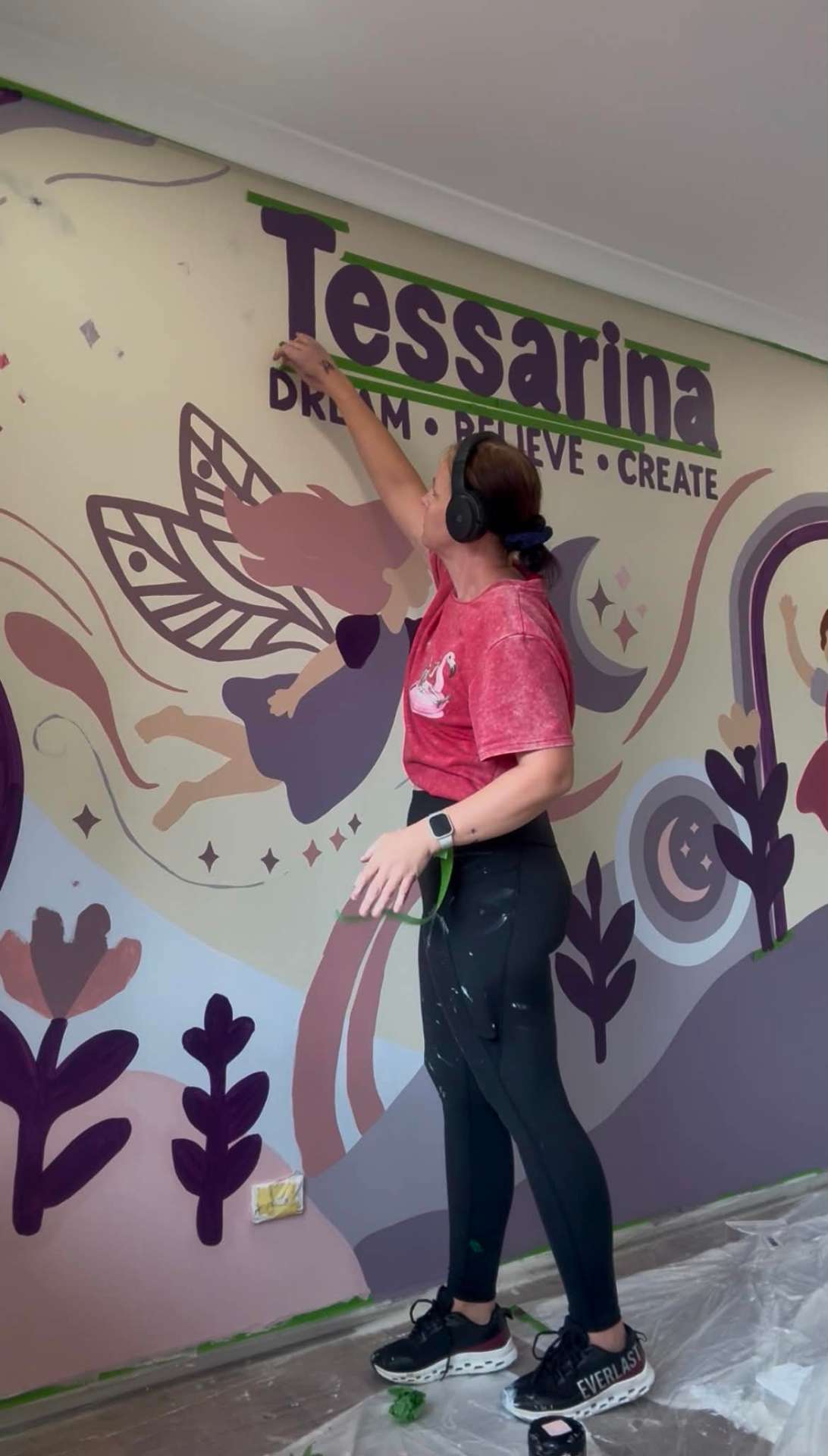 Ashleigh, Brisbane mural artist behind Your Local Mural, painting a wall on site